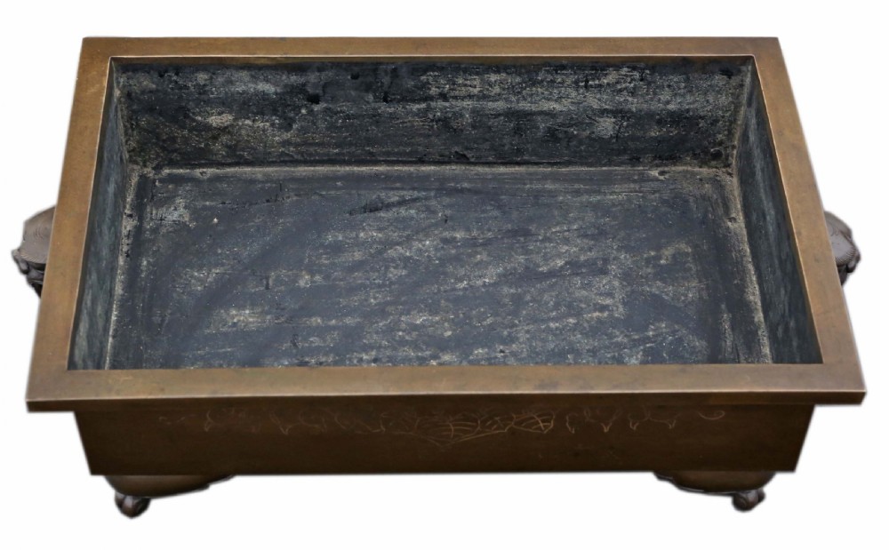 A rectangular Japanese bronze suiban planter featuring incised foliage motifs on the front panel and raised corner feet. View VII