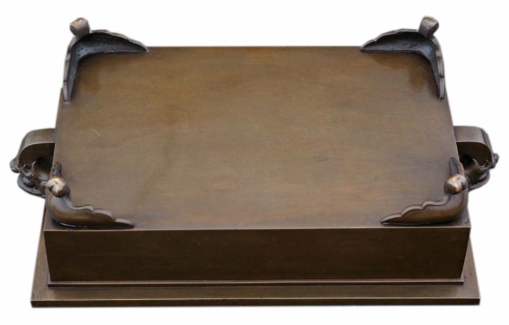 A rectangular Japanese bronze suiban planter featuring incised foliage motifs on the front panel and raised corner feet. View VIII