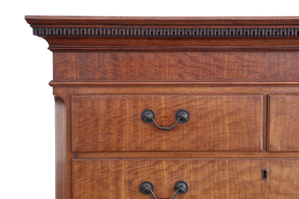 A nineteenth-century mahogany tallboy chest on chest featuring figured wood drawer fronts, brass drop handles, a dentil cornice, and splayed bracket feet. View III