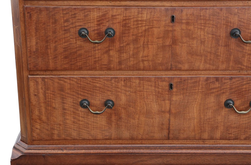 A nineteenth-century mahogany tallboy chest on chest featuring figured wood drawer fronts, brass drop handles, a dentil cornice, and splayed bracket feet. View V