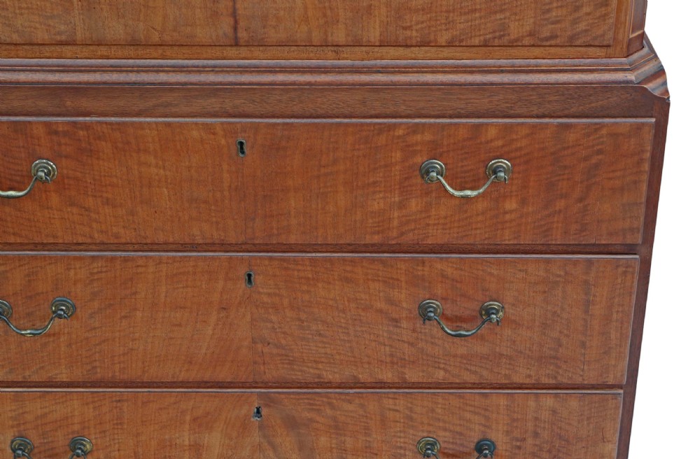 A nineteenth-century mahogany tallboy chest on chest featuring figured wood drawer fronts, brass drop handles, a dentil cornice, and splayed bracket feet. View VIII