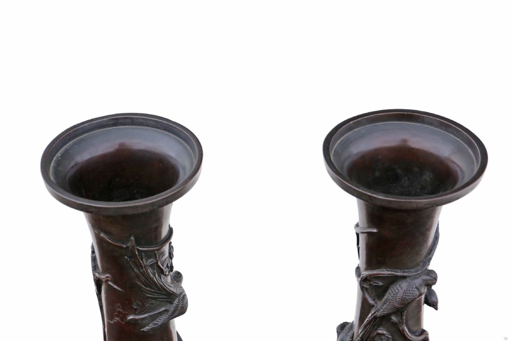 A pair of large 19th-century Japanese bronze vases decorated with high-relief bird and blossom carvings on cylindrical necks above pattern-embossed bulbous bases. View III