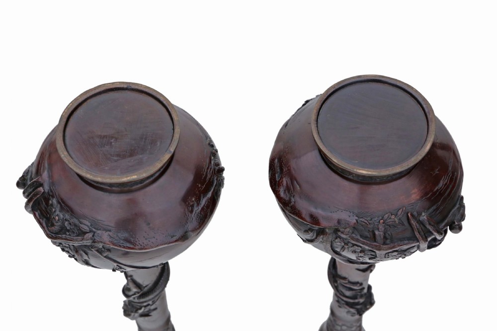 A pair of tall 19th-century Japanese bronze vases with relief-carved dragons coiling around slender necks and bird motifs on rounded bases. View V