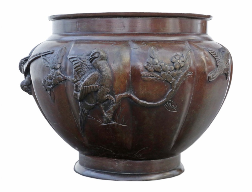 A large lobed dark bronze Japanese Meiji period jardiniere featuring raised high-relief carvings of birds perched on blossoming branches. View II
