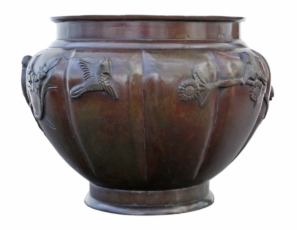 A large lobed dark bronze Japanese Meiji period jardiniere featuring raised high-relief carvings of birds perched on blossoming branches. View III