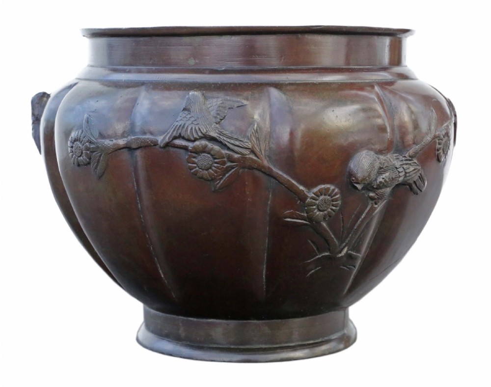 A large lobed dark bronze Japanese Meiji period jardiniere featuring raised high-relief carvings of birds perched on blossoming branches. View IV