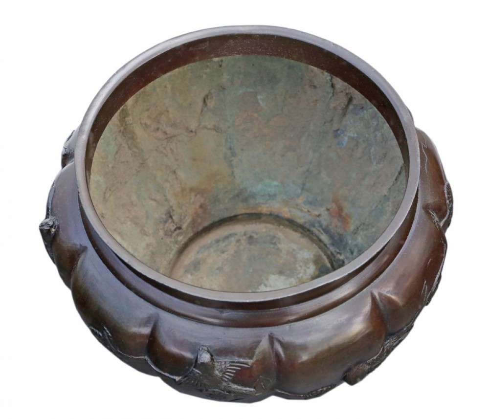 A large lobed dark bronze Japanese Meiji period jardiniere featuring raised high-relief carvings of birds perched on blossoming branches. View V