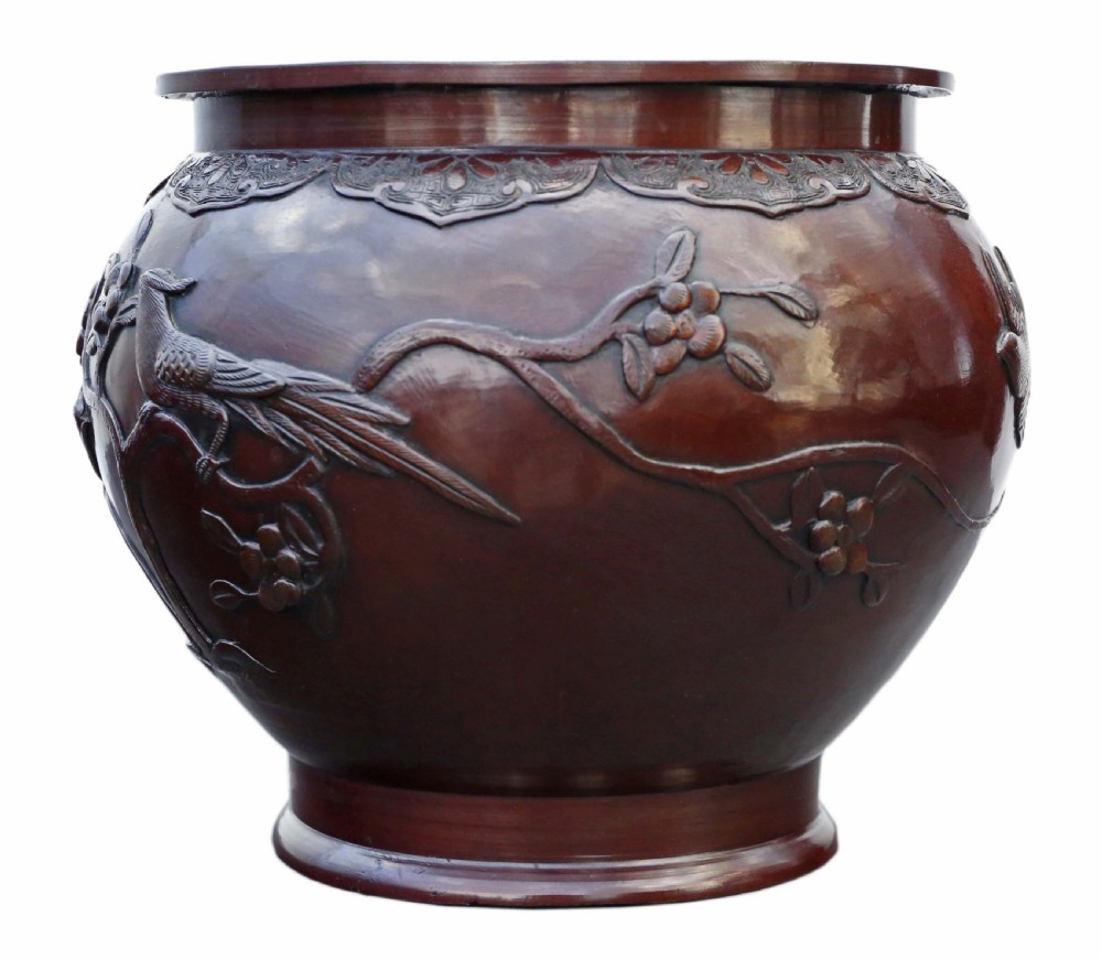 A dark brown patinated Japanese bronze jardiniere featuring high-relief relief carvings of birds perched on flowering branches. View III