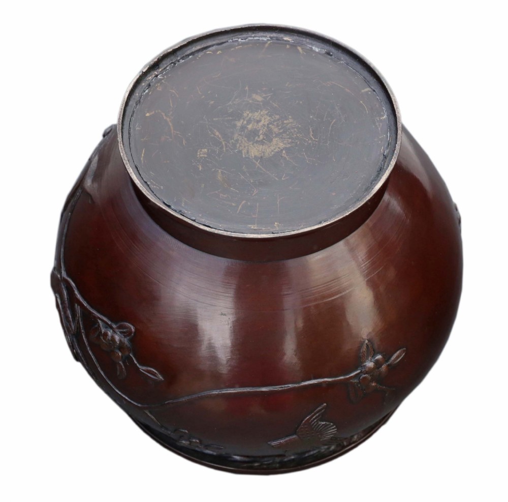 A dark brown patinated Japanese bronze jardiniere featuring high-relief relief carvings of birds perched on flowering branches. View IV