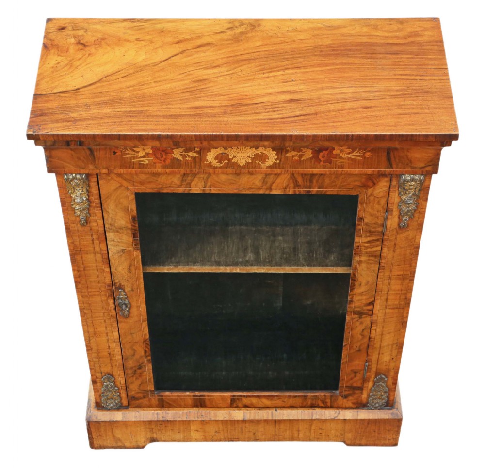 A Victorian burr walnut pier display cabinet featuring a single glazed door, floral marquetry inlay at the upper frieze, and brass mounts on the sides. View II