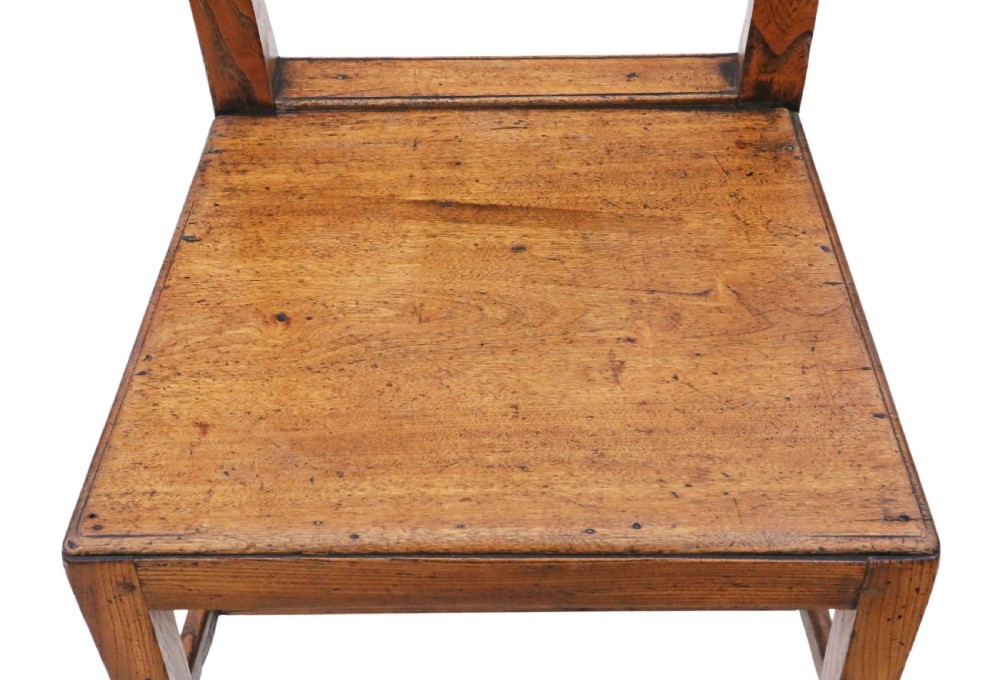 A set of six 19th-century elm dining chairs featuring lattice-carved back splats, wooden panel seats, and sturdy stretchers, including five side chairs and one carver armchair. View X