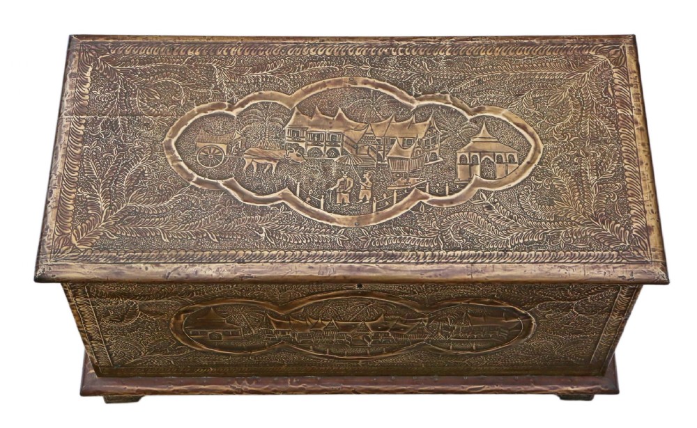 A rectangular wooden storage chest fully encased in hand-embossed brass sheeting featuring Chinoiserie landscape scenes and foliate borders. View III