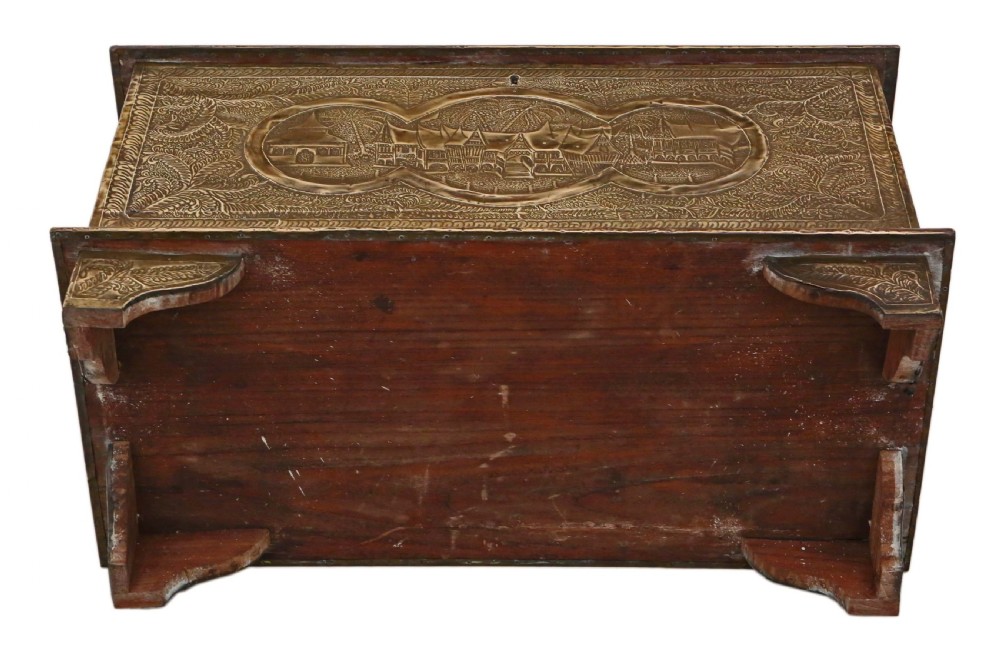 A rectangular wooden storage chest fully encased in hand-embossed brass sheeting featuring Chinoiserie landscape scenes and foliate borders. View IX