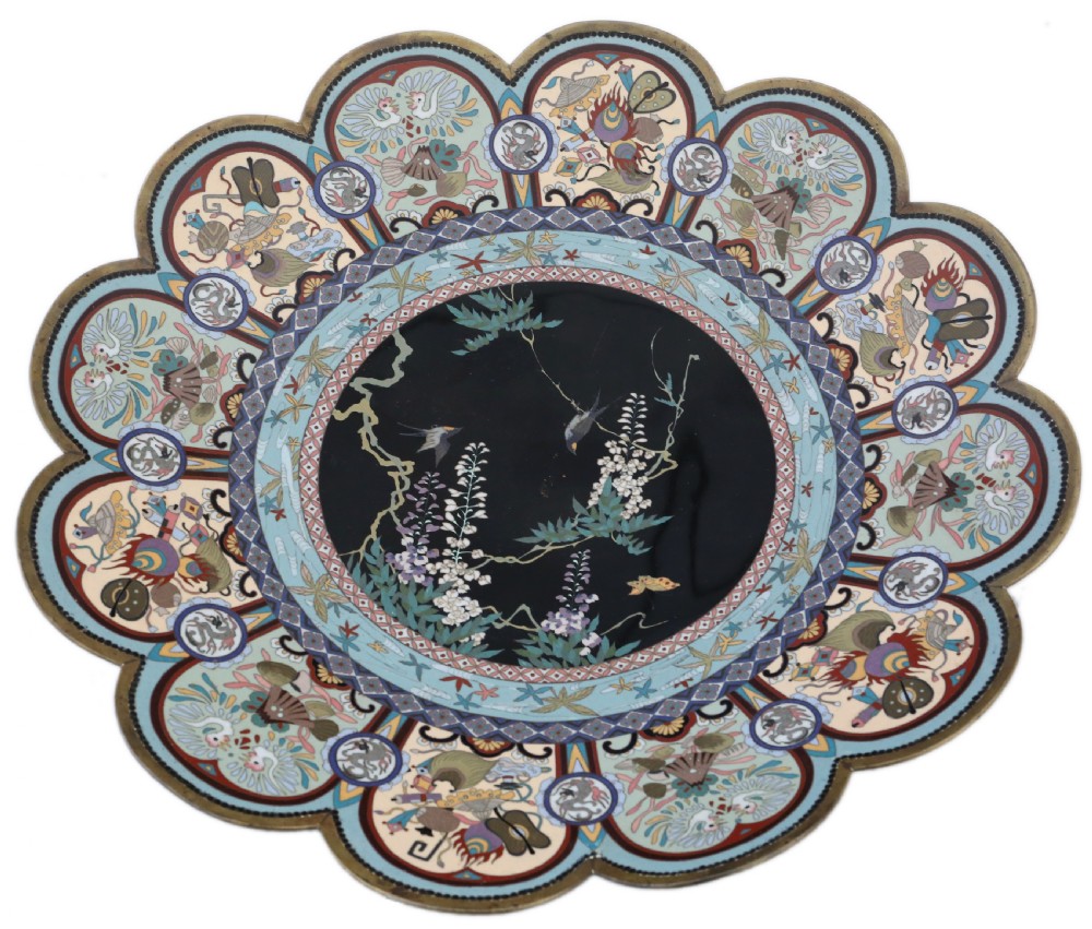 A large Japanese Meiji period scalloped cloisonne charger plate featuring a black central panel decorated with wisteria and birds, framed by intricate polychrome enamel outer borders. View II