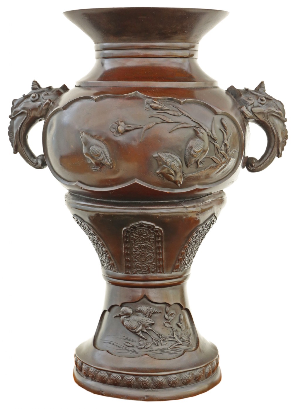A large 19th-century Japanese Meiji period patinated bronze urn featuring relief-carved avian panels, twin beast-head handles, and a stepped circular pedestal base. View II