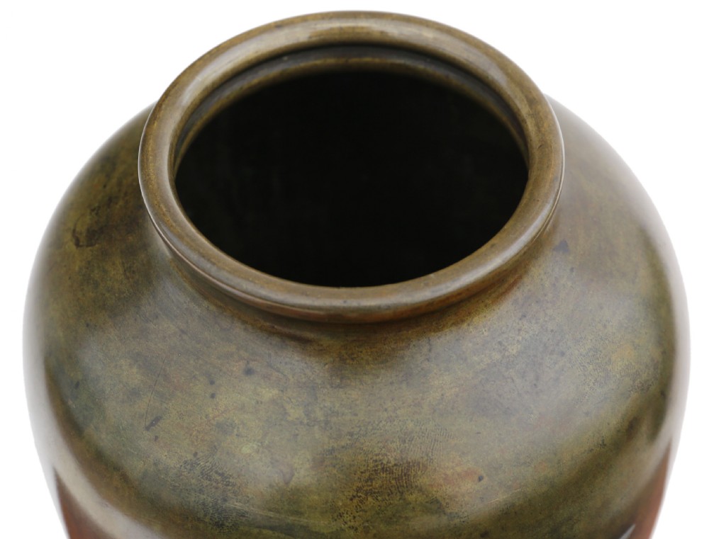 A Japanese Meiji period bronze vase featuring a relief-carved heron standing among aquatic reeds against a patinated dark brown surface. View V