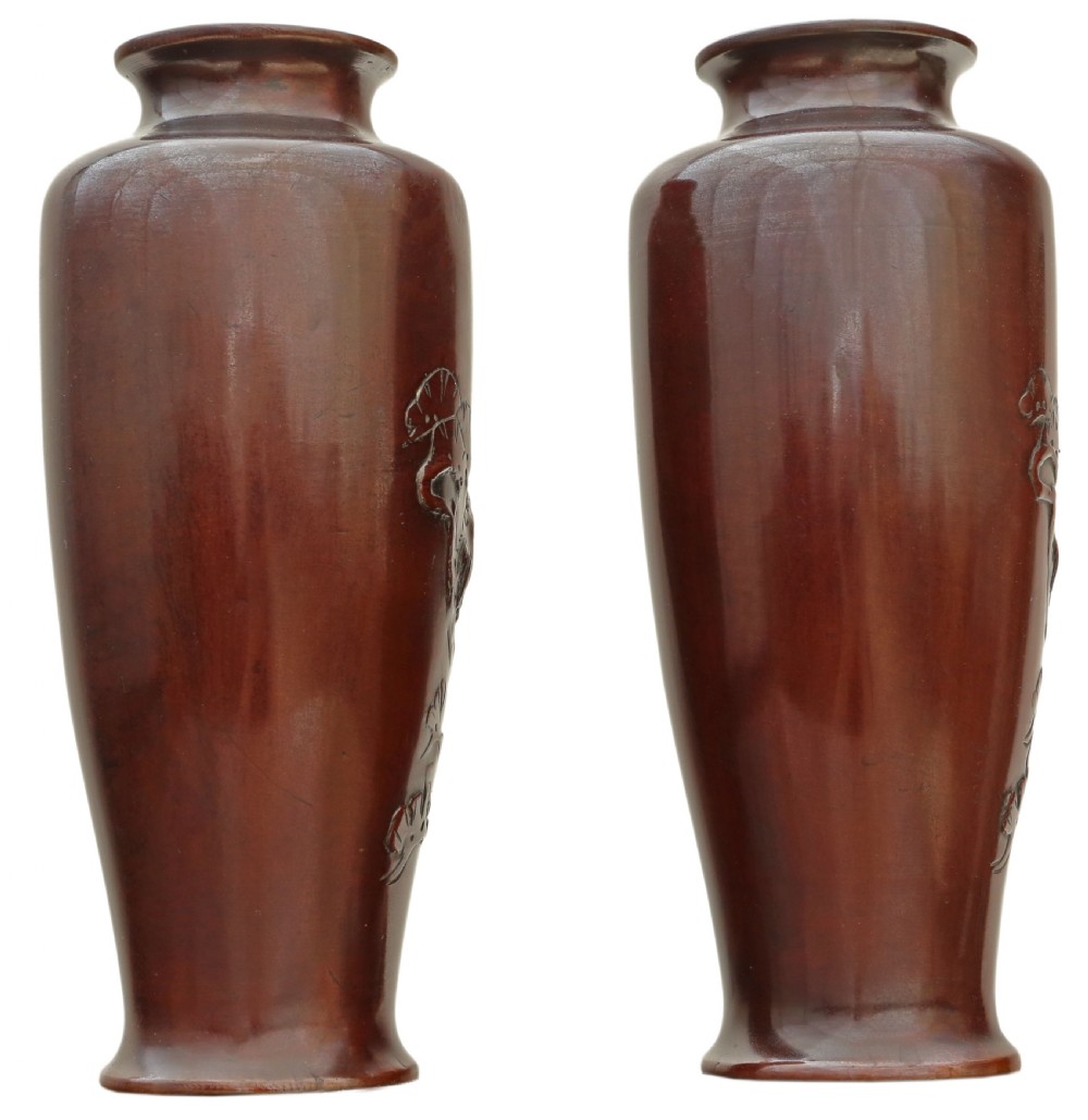 Pair of Japanese bronze vases featuring raised relief carving of cranes standing amongst foliage against a rich brown patina. View II