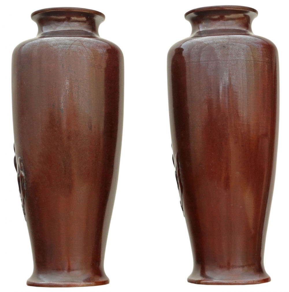 Pair of Japanese bronze vases featuring raised relief carving of cranes standing amongst foliage against a rich brown patina. View VI