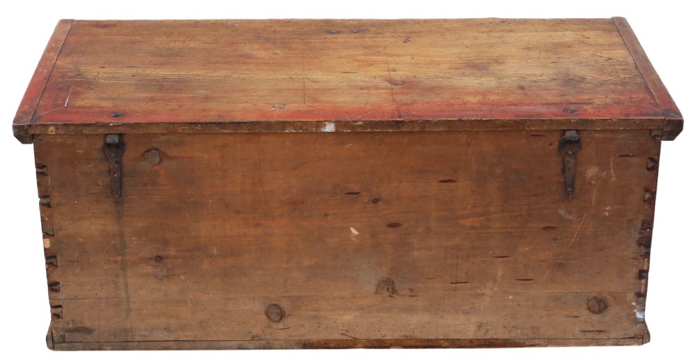 An antique rectangular wooden coffer with a natural pine lid and a red and dark green painted front featuring three arched panels with floral motifs. View VII