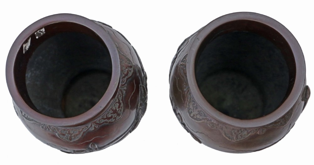 A pair of dark brown patinated Japanese Meiji period bronze vases featuring high relief carvings of birds perched on branches with geometric borders. View III
