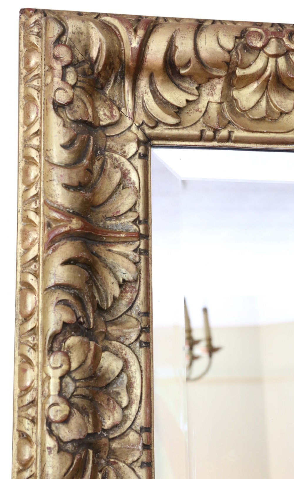 A rectangular gilded wall mirror featuring a carved leaf motif border with bevelled edge mirror glass. View III