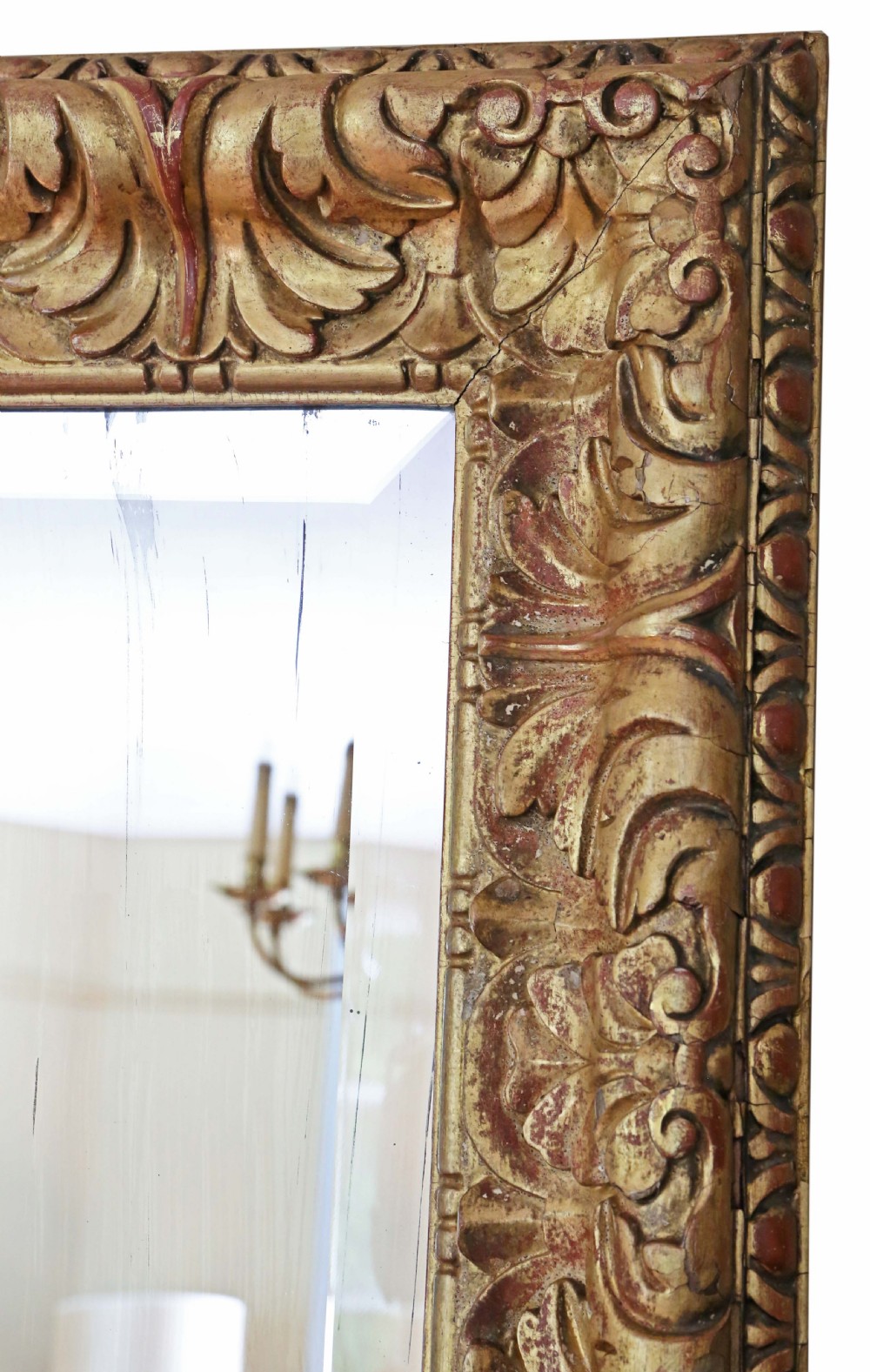 A rectangular gilded wall mirror featuring a carved leaf motif border with bevelled edge mirror glass. View IV