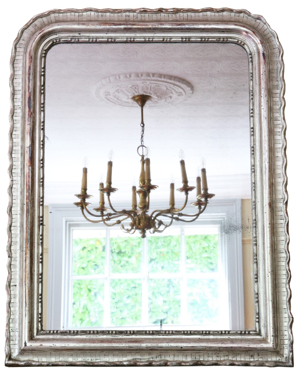 A large 19th-century silver gilt rectangular overmantel mirror featuring rounded upper corners, beaded inner moulding, and a textured ribbed outer frame.