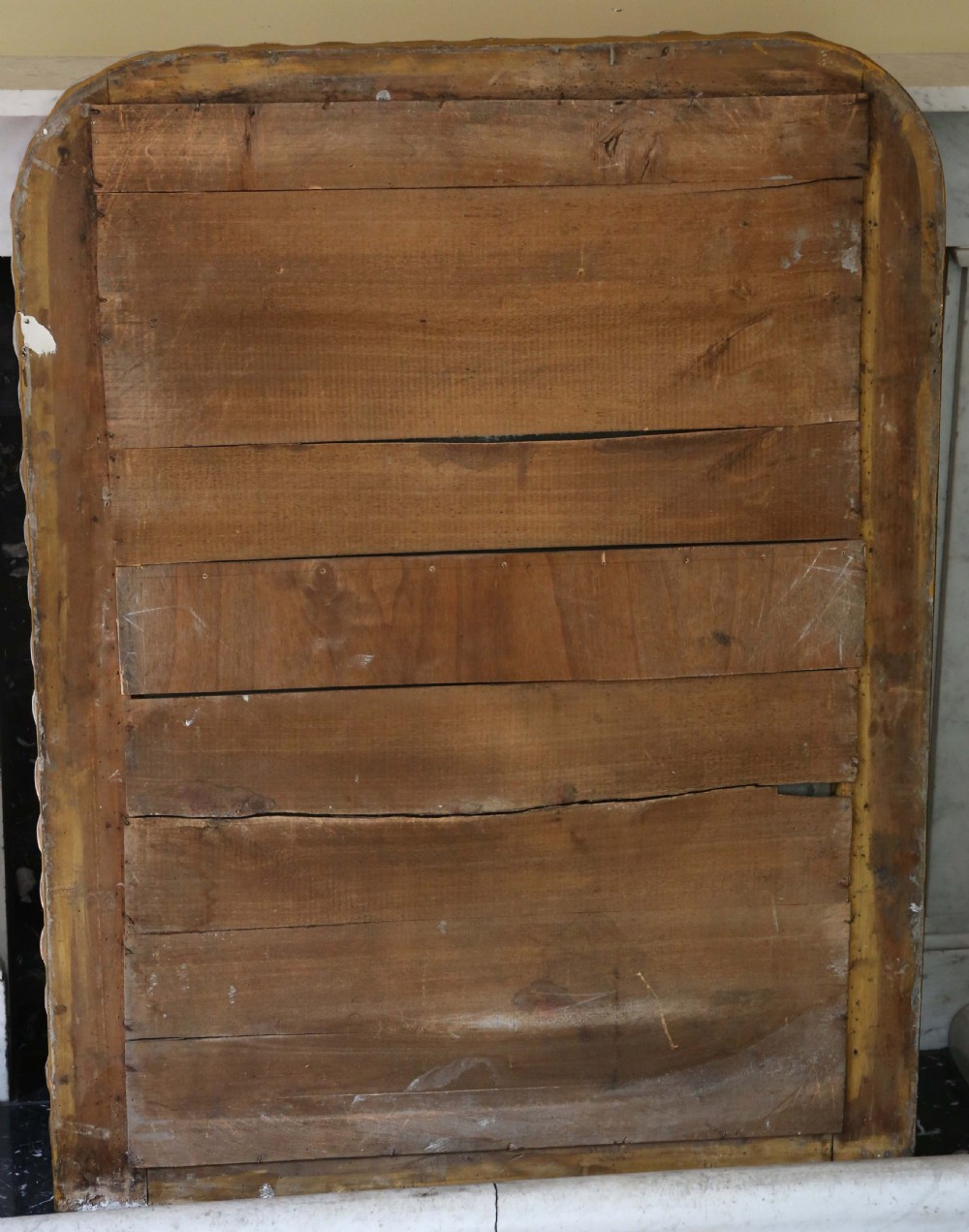 A large 19th-century silver gilt rectangular overmantel mirror featuring rounded upper corners, beaded inner moulding, and a textured ribbed outer frame. View V