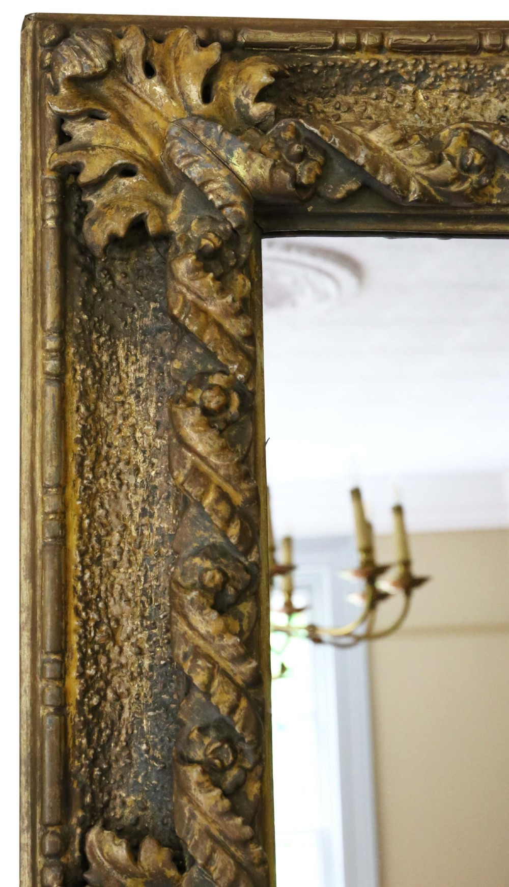 A large rectangular 19th-century wall mirror featuring a heavily carved giltwood frame decorated with acanthus leaf motifs. View II
