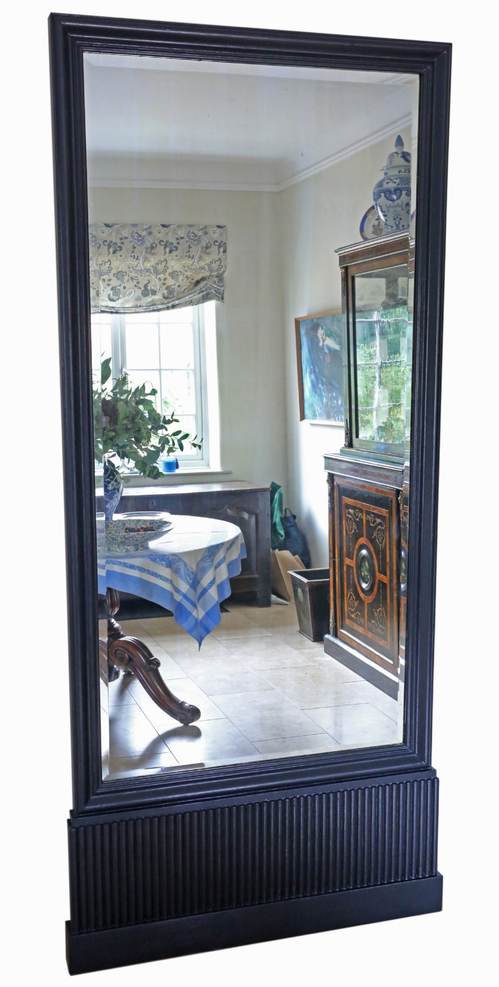 A tall rectangular full-height floor mirror set in a black painted wooden frame with a reeded plinth base.