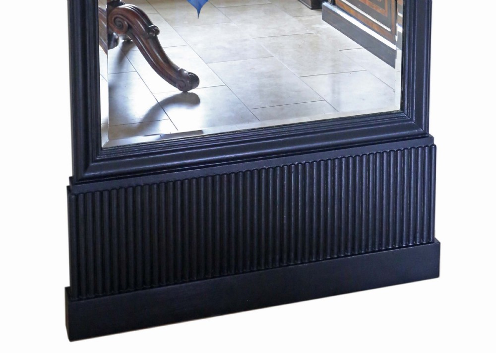 A tall rectangular full-height floor mirror set in a black painted wooden frame with a reeded plinth base. View IV