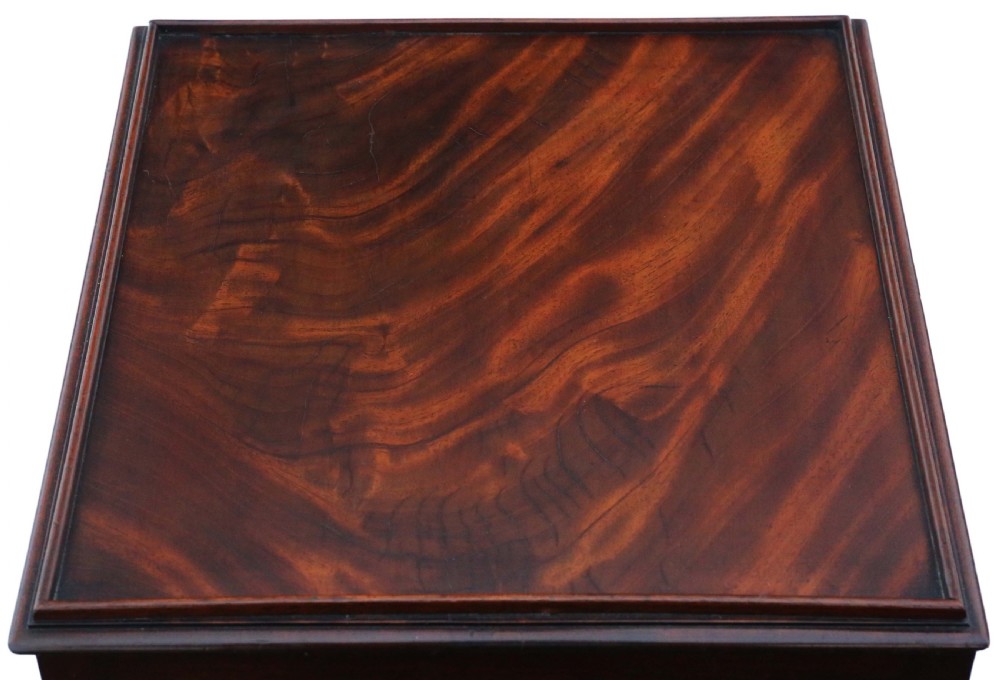 An antique Georgian mahogany bedside table featuring a flame mahogany tray top, an open shelf, a single drawer with a brass knob, and an X-shaped lower stretcher. View II