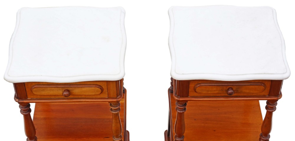 A pair of French walnut bedside tables featuring white marble tops, single upper drawers, open central shelves supported by turned columns, and lower single-door cupboards. View II