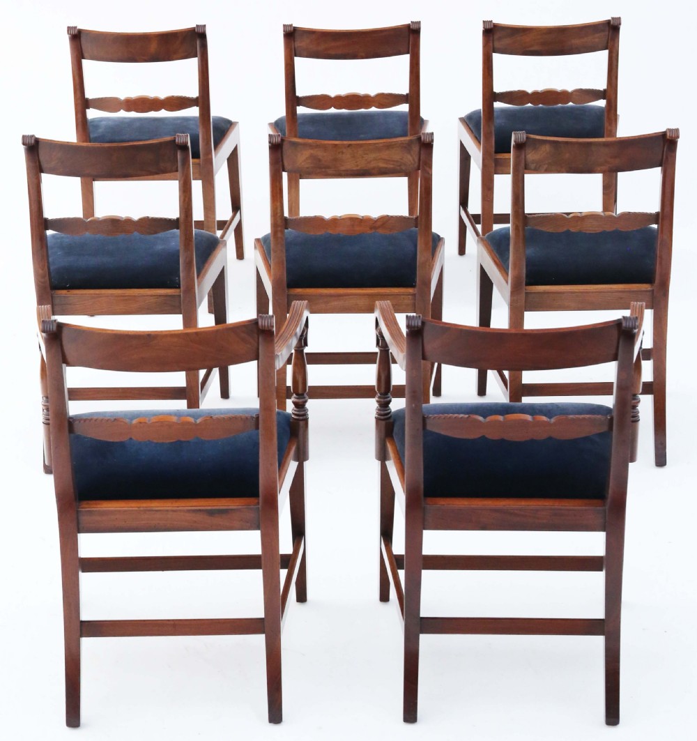 A set of eight Regency mahogany dining chairs featuring six single chairs and two carvers with dark blue velvet upholstered seats. View II