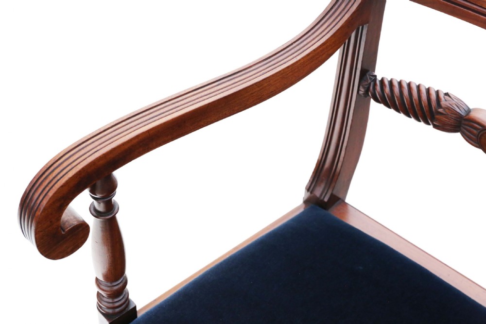 A set of eight Regency mahogany dining chairs featuring six single chairs and two carvers with dark blue velvet upholstered seats. View V