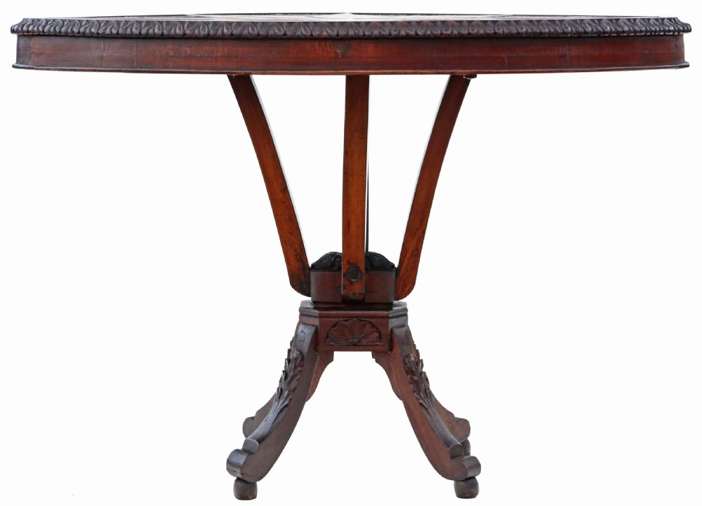 An antique Anglo-Indian carved wooden occasional table with a shield-shaped top featuring a starburst pattern on a pedestal base. View IV