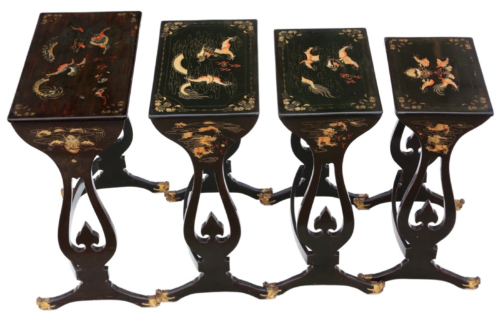 A nineteenth-century nest of four black lacquer tables featuring hand-painted Chinese dragon motifs in gold and red with shaped lyre legs. View II