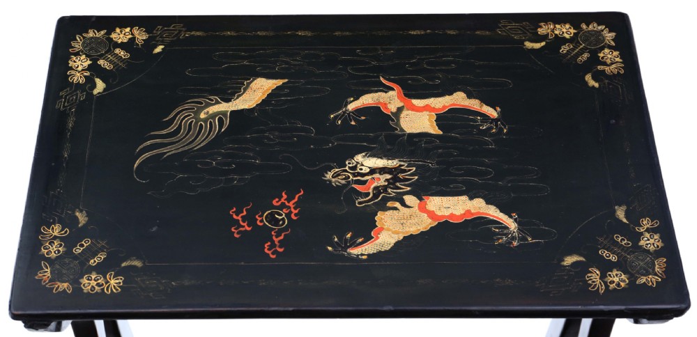 A nineteenth-century nest of four black lacquer tables featuring hand-painted Chinese dragon motifs in gold and red with shaped lyre legs. View V