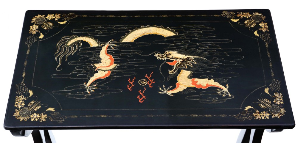 A nineteenth-century nest of four black lacquer tables featuring hand-painted Chinese dragon motifs in gold and red with shaped lyre legs. View VI