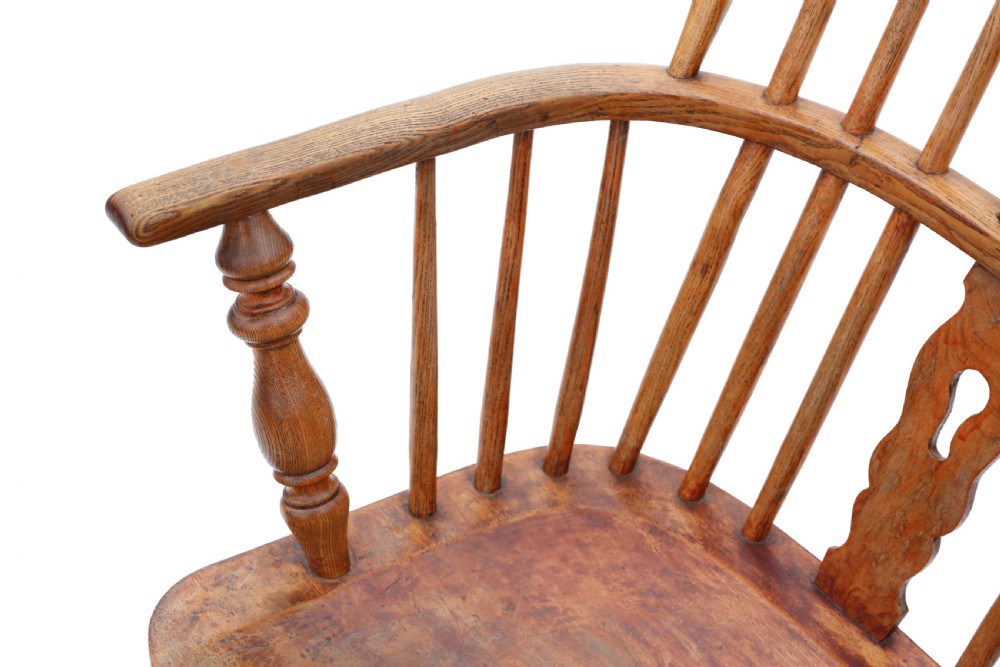 A nineteenth-century English Windsor armchair made from ash and elm wood, featuring a hoop back, pierced central splat, turned legs, and a saddle seat. View IV