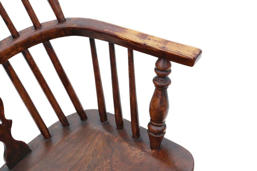 A 19th-century wooden Windsor armchair featuring a hoop back, central pierced splat, spindled backrest, shaped saddle seat, and turned legs. View IV