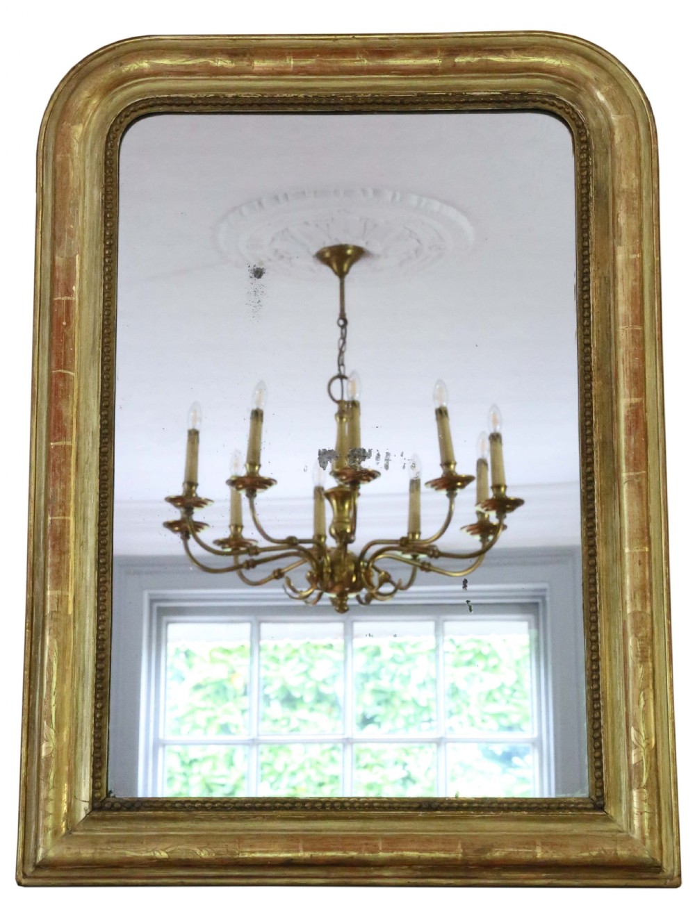 A 19th-century French Louis Philippe giltwood overmantel mirror with rounded top corners, beaded inner moulding, and visible red bole under distressed gold leaf.