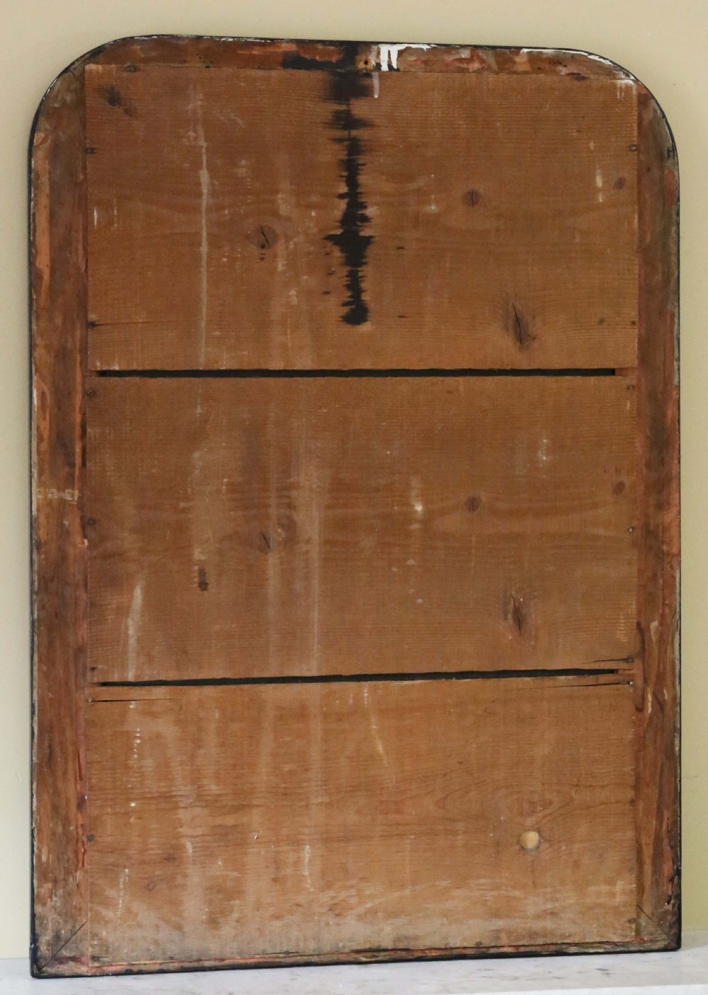 A nineteenth-century rectangular overmantel mirror with rounded top corners, featuring a dark ebonised frame bordered by ornate gilt mouldings. View VII