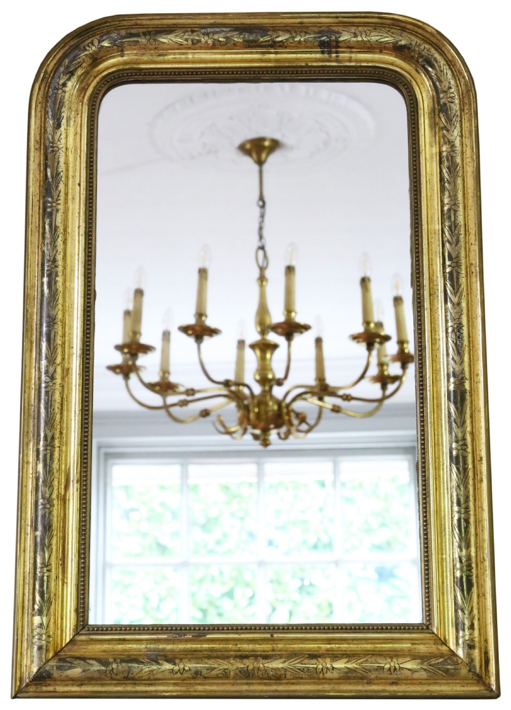 A nineteenth-century French Louis Philippe overmantel wall mirror featuring a gilt frame with rounded upper corners, engraved foliage motifs, and a beaded inner moulding.