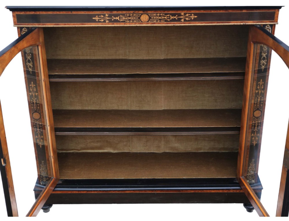 A late 19th-century Aesthetic Movement ebonised and burr walnut pier display cabinet with twin glazed doors and marquetry inlay. View III