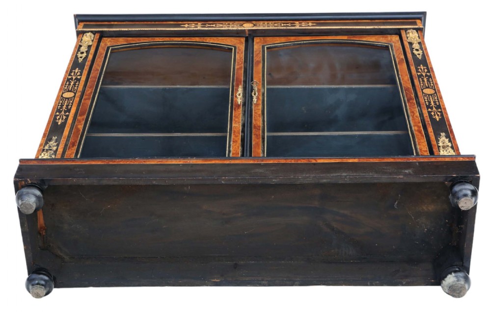 A late 19th-century Aesthetic Movement ebonised and burr walnut pier display cabinet with twin glazed doors and marquetry inlay. View VI
