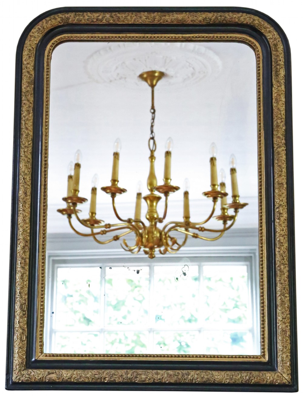 A nineteenth-century rectangular overmantel mirror with rounded top corners, featuring a dark ebonised frame bordered by ornate gilt mouldings.