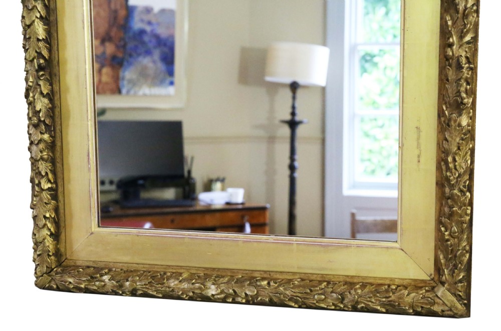 A large 19th-century rectangular wall mirror featuring a gilded frame with a carved leaf outer border and flat inner profile. View III