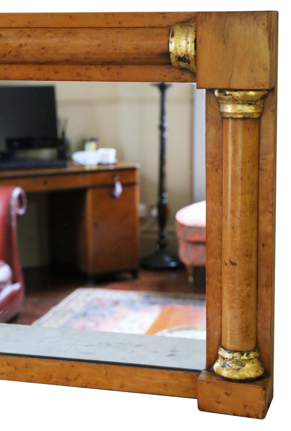 A 19th-century rectangular overmantel wall mirror featuring a birds eye maple veneer frame flanked by half-columns with giltwood capitals. View II