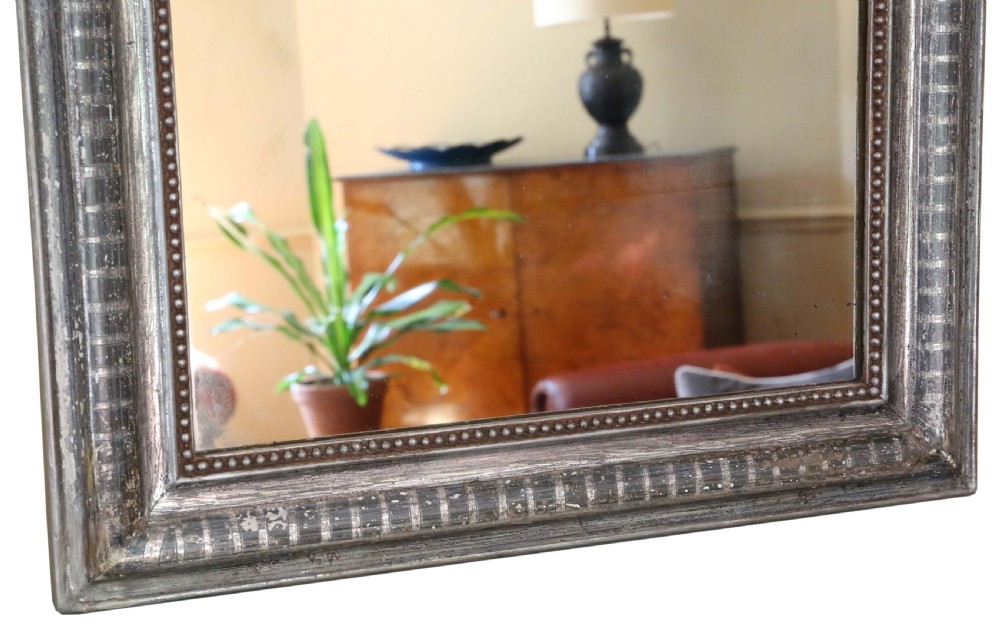 A 19th-century silver gilt overmantel mirror featuring rounded top corners, incised linear moulding, and a beaded inner frame. View III